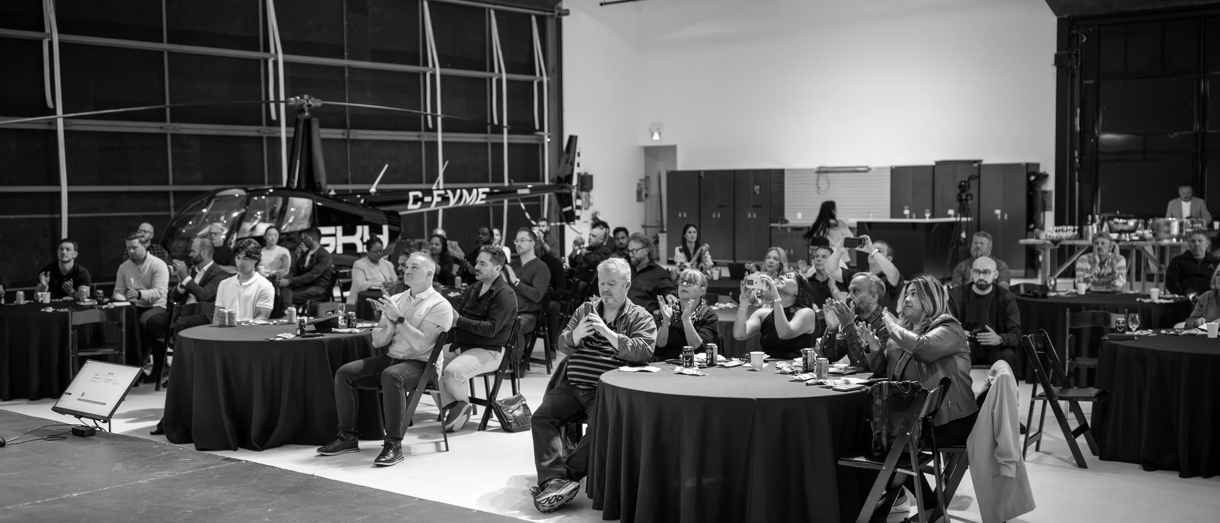 An audience applauding at the end of a Hangar Hangout session in Vancouver