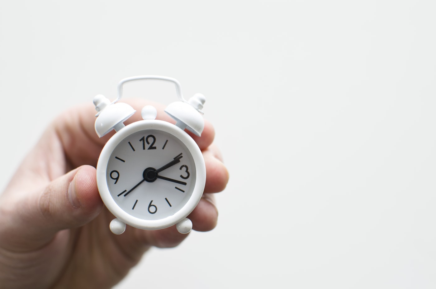 Alarm clock and calendar on a desk at dawn